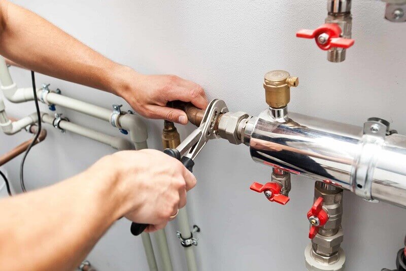 Commercial plumber in Penrith performing a routine maintenance check on a restaurant's kitchen